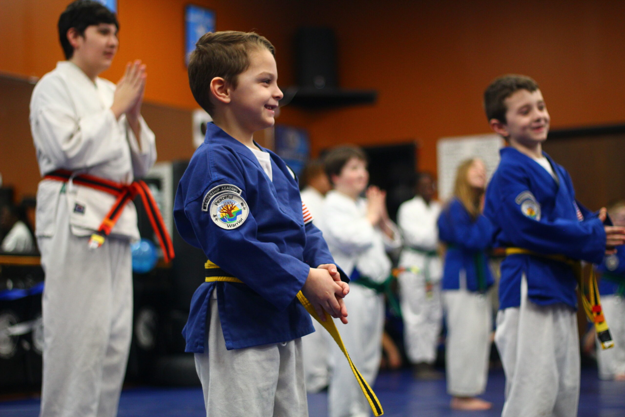 Young martial arts students smiling and participating in class